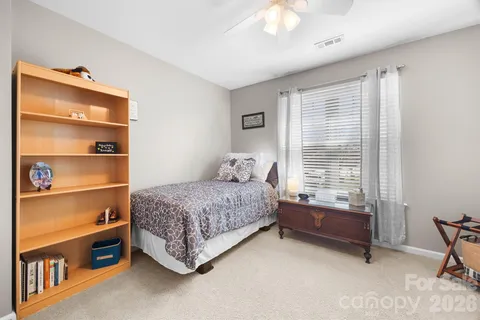 a bedroom with bed and a window