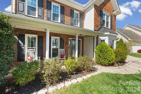 front view of a brick house with a yard