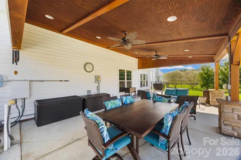 a view of a patio with a dining table and chairs