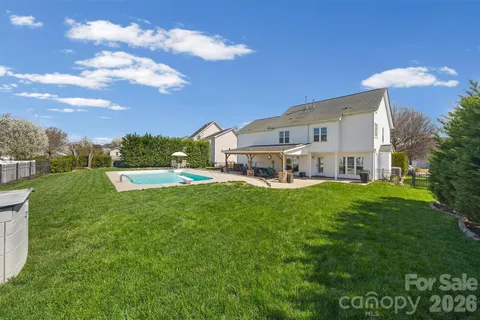 a view of house with backyard outdoor seating and green space