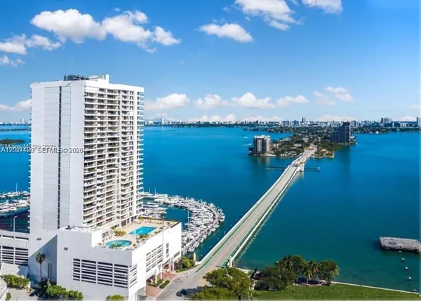 a view of a lake with a city skyline in the background