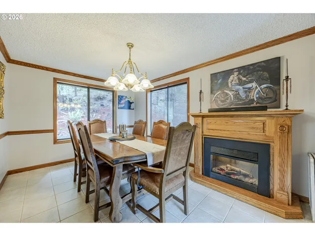 a dining room with furniture a fireplace and a chandelier
