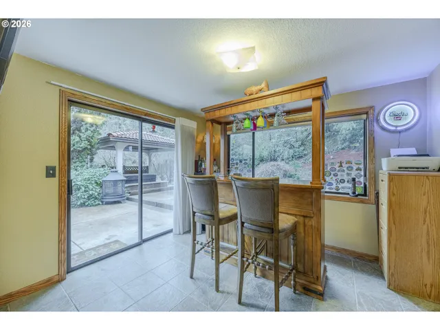 a dining room with furniture and a window
