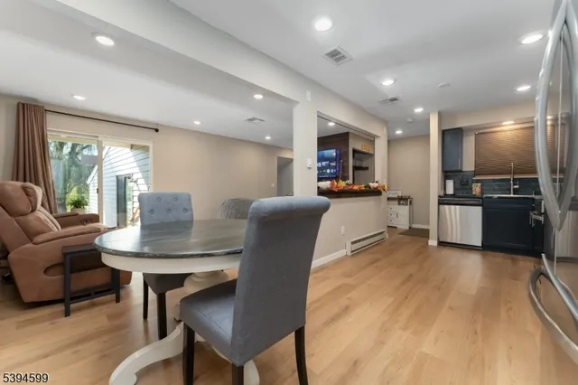 a living room with furniture and kitchen view