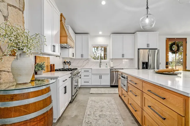 a kitchen with sink stove and refrigerator