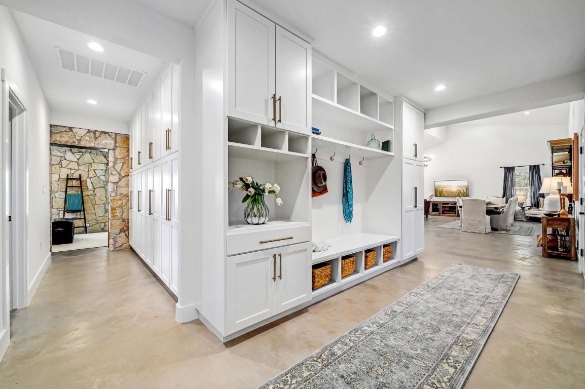 1668 Rocky Road Blanco, TX 78606 - Photo 14 of 33 a hallway with white cabinets and white appliances