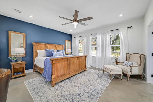 a bedroom with a bed and a couch