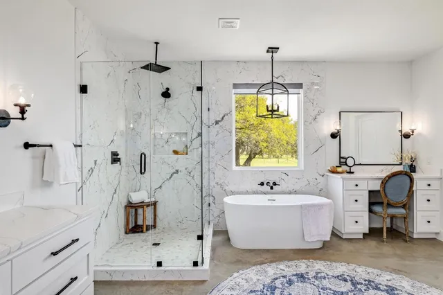a bathroom with a tub sink and mirror