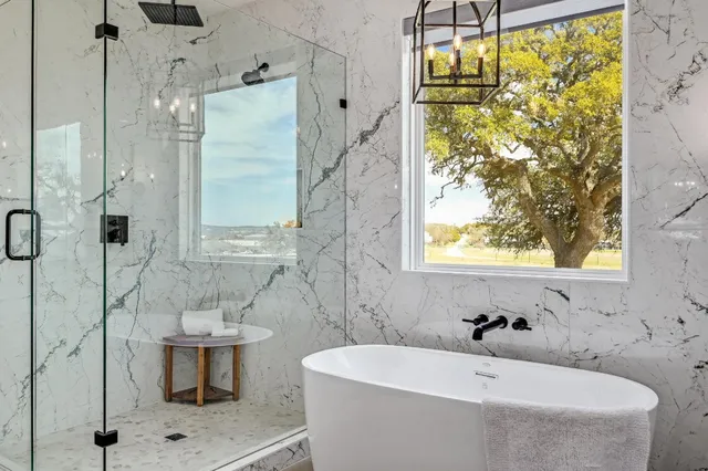 a bath tub sitting in a bathroom next to a window
