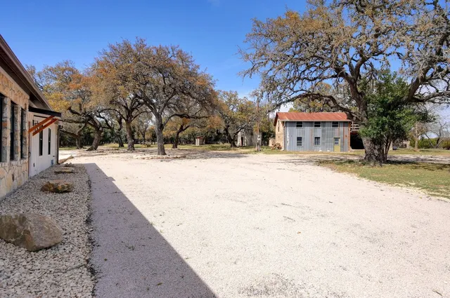 a view of a white house with a yard