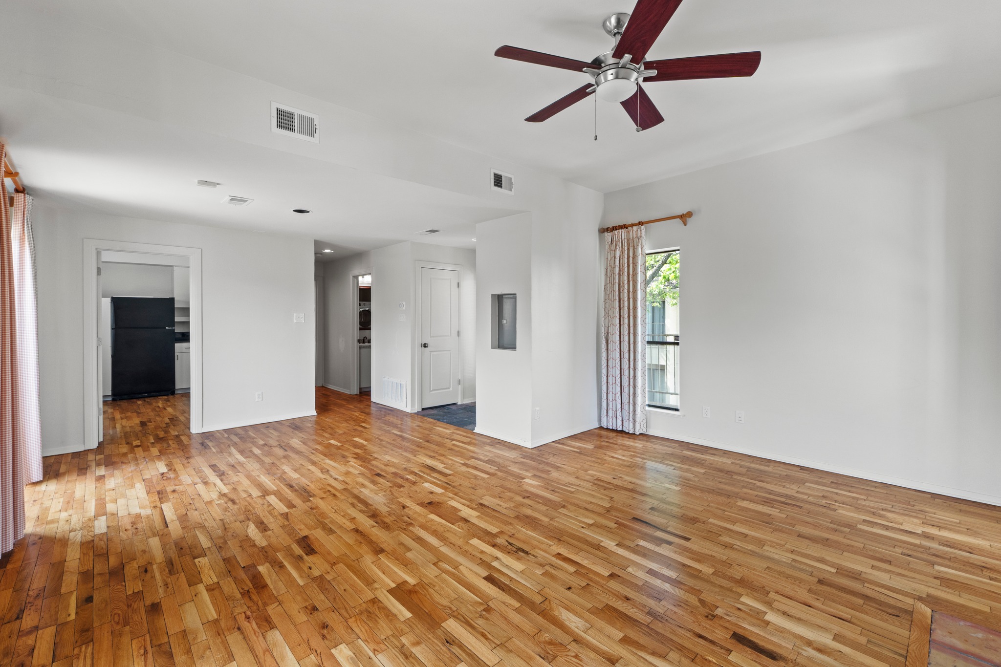 409 East 38th Street, Unit 305 Austin, TX 78705 - Photo 5 of 22 Another view from the fireplace wall facing the kitchen/hallway to bedroom where you can see the front entrance.