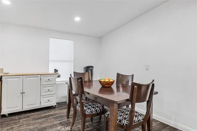 a view of a dining room that has a table and chairs in it