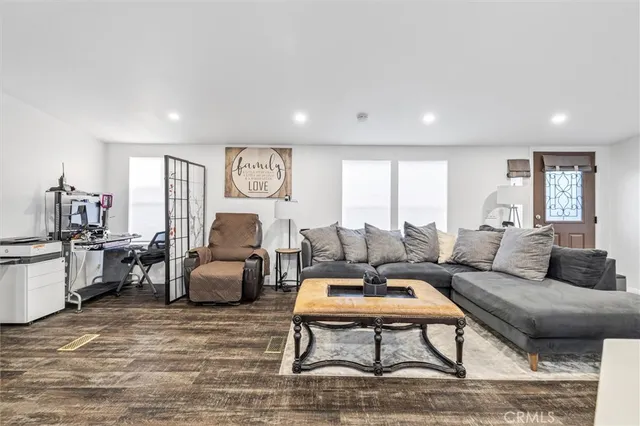 a living room with furniture or couch and a kitchen view
