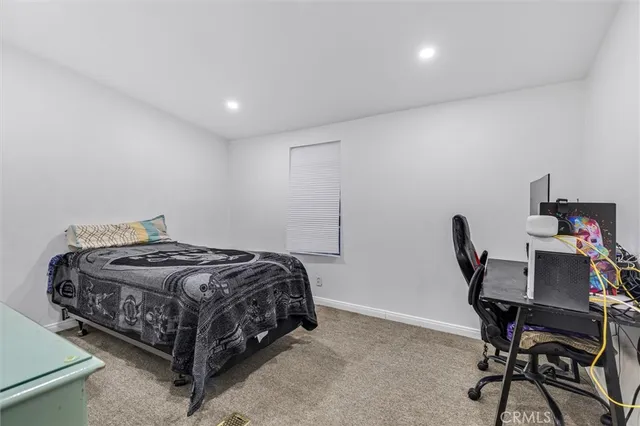 a bedroom with a bed and a desk