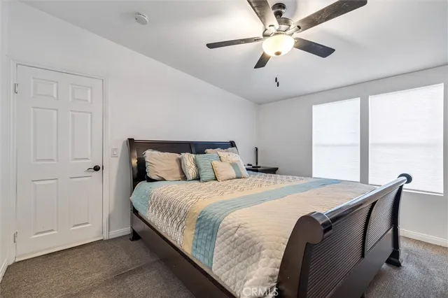 a bedroom with bed and window