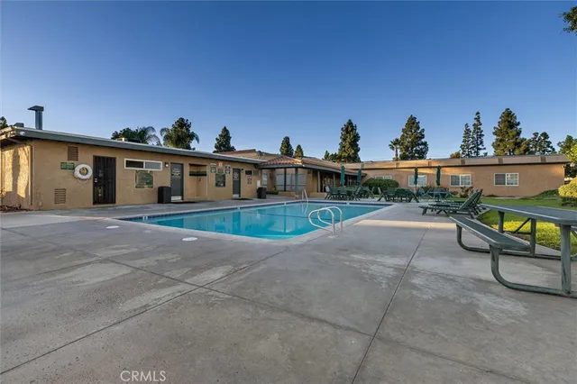 a view of a white house with a yard