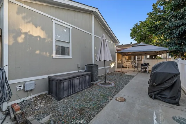 a view of a house with backyard and sitting area