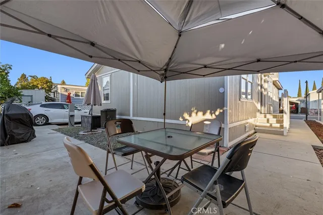 a outdoor dining area with furniture and a potted plant
