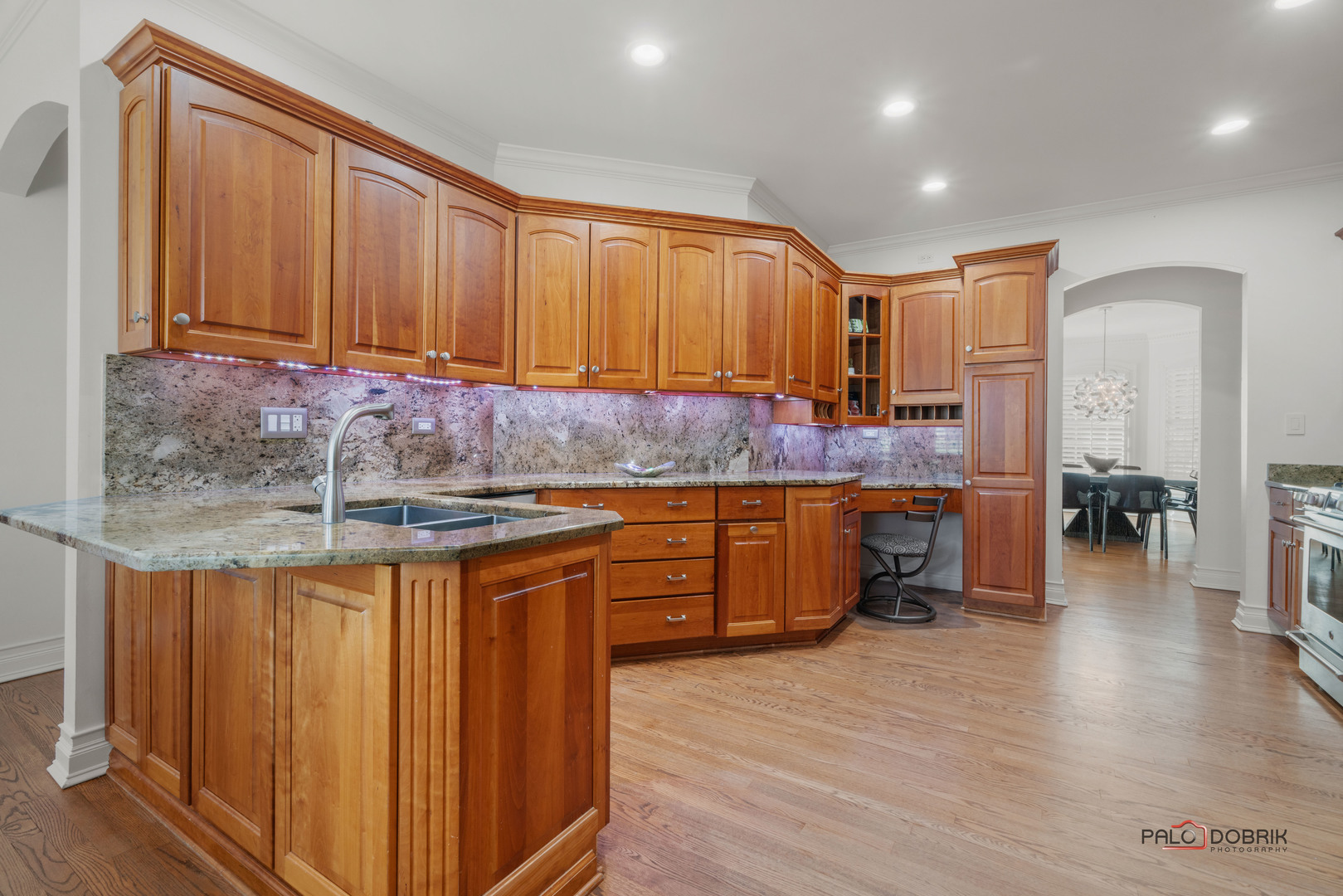 2307 Old Hicks Road Long Grove, IL 60047 - Photo 14 of 59 a kitchen with stainless steel appliances granite countertop wooden cabinets a sink and dishwasher a stove with wooden floor