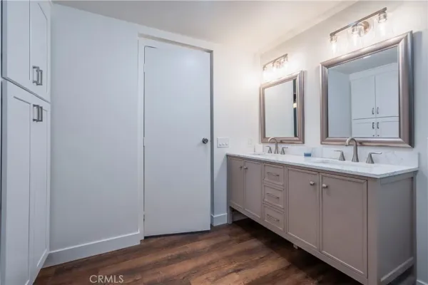 a spacious bathroom with a double vanity sink and a mirror