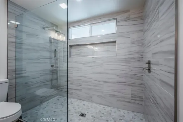 a bathroom with a shower and toilet