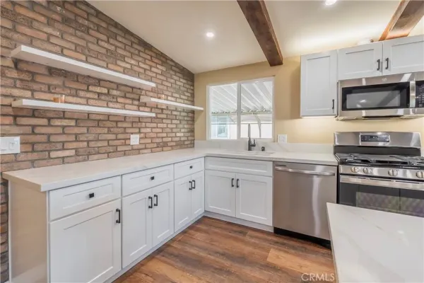 a kitchen with stainless steel appliances granite countertop a stove and a sink