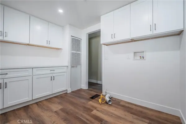 a view of a kitchen with wooden cabinet