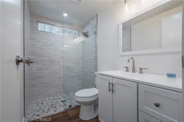 a bathroom with a sink a toilet and shower