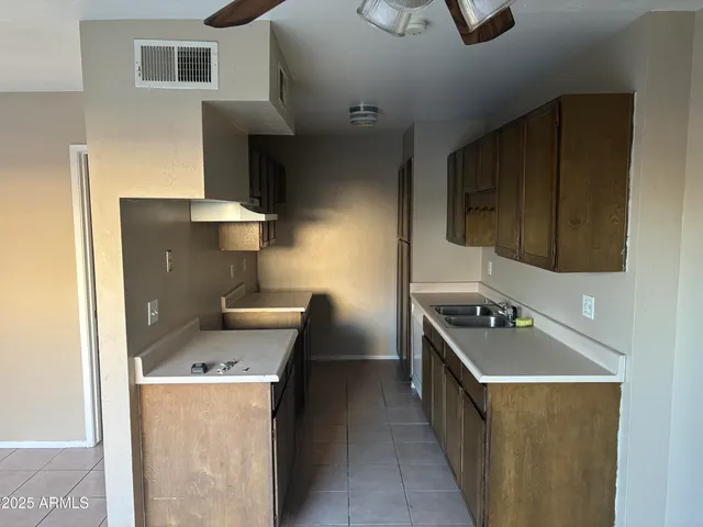 a kitchen with a stove and a refrigerator