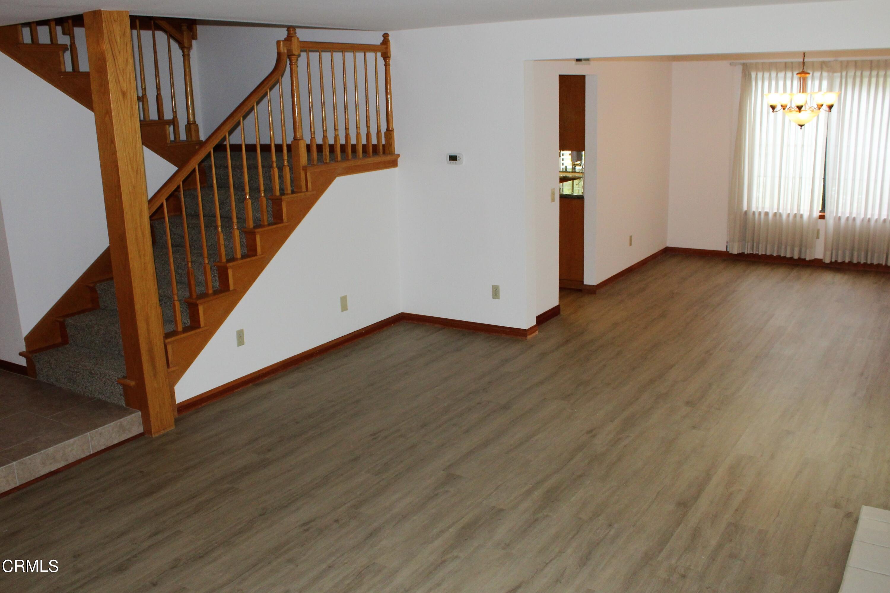 2202 Firestone Court Oxnard, CA 93036 - Photo 18 of 51 a view of a hallway with wooden floor and stairs