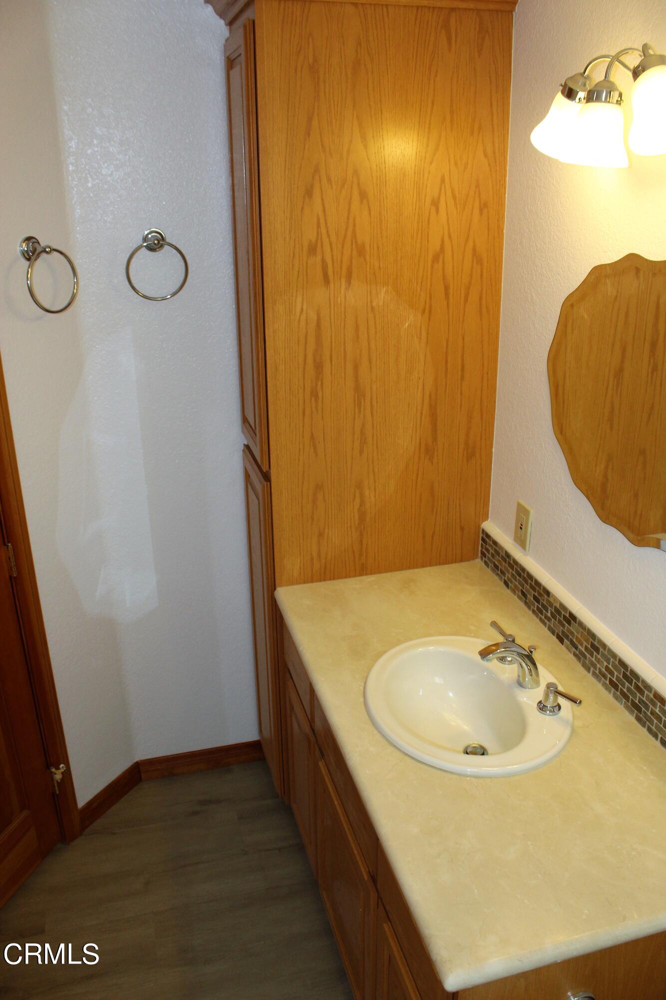 2202 Firestone Court Oxnard, CA 93036 - Photo 23 of 51 a bathroom with a sink and a mirror