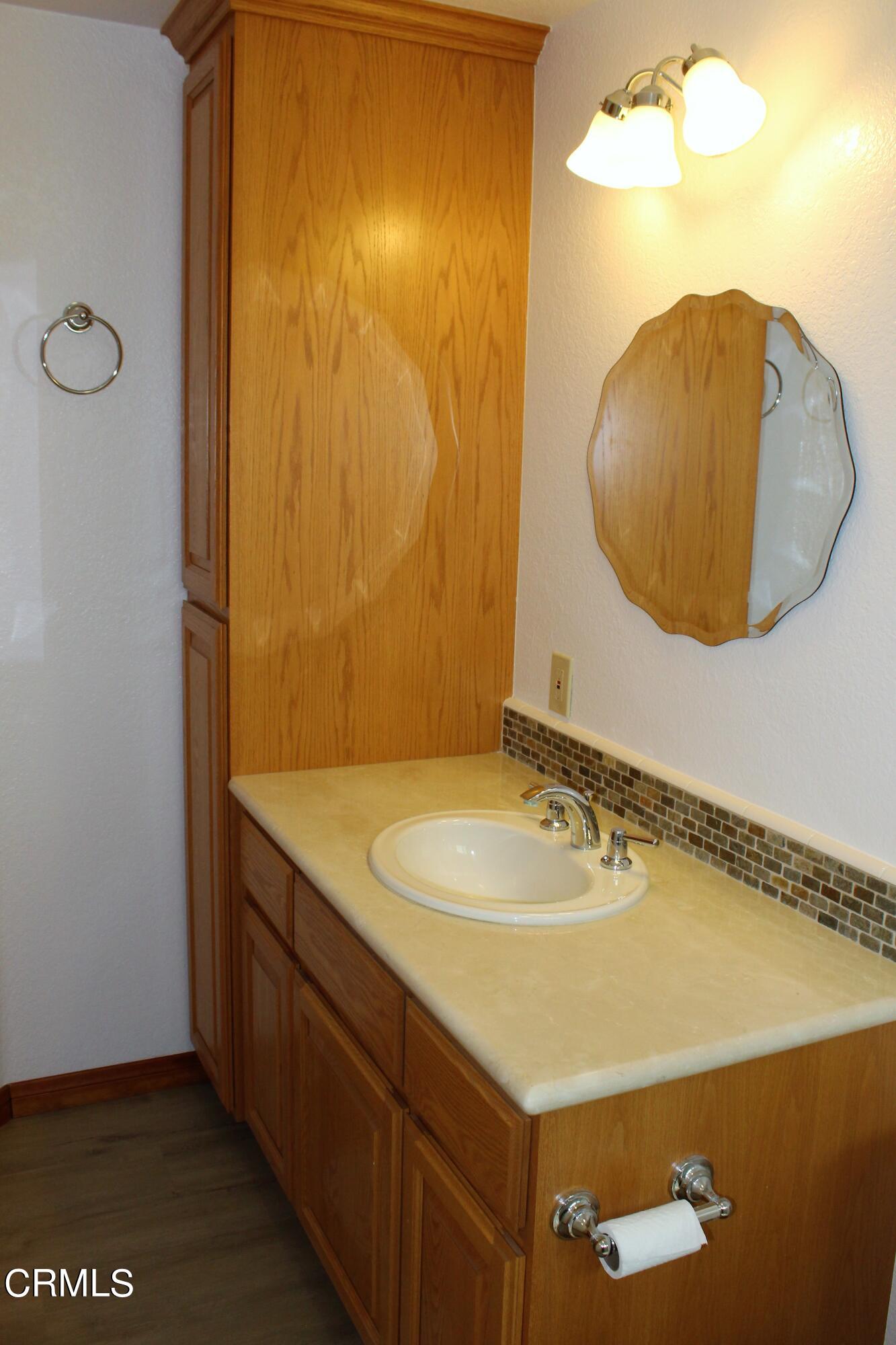 2202 Firestone Court Oxnard, CA 93036 - Photo 24 of 51 a bathroom with a sink and a mirror
