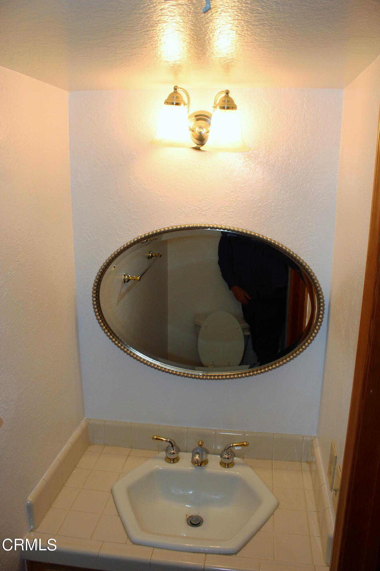 2202 Firestone Court Oxnard, CA 93036 - Photo 26 of 51 a bathroom with a sink and mirror