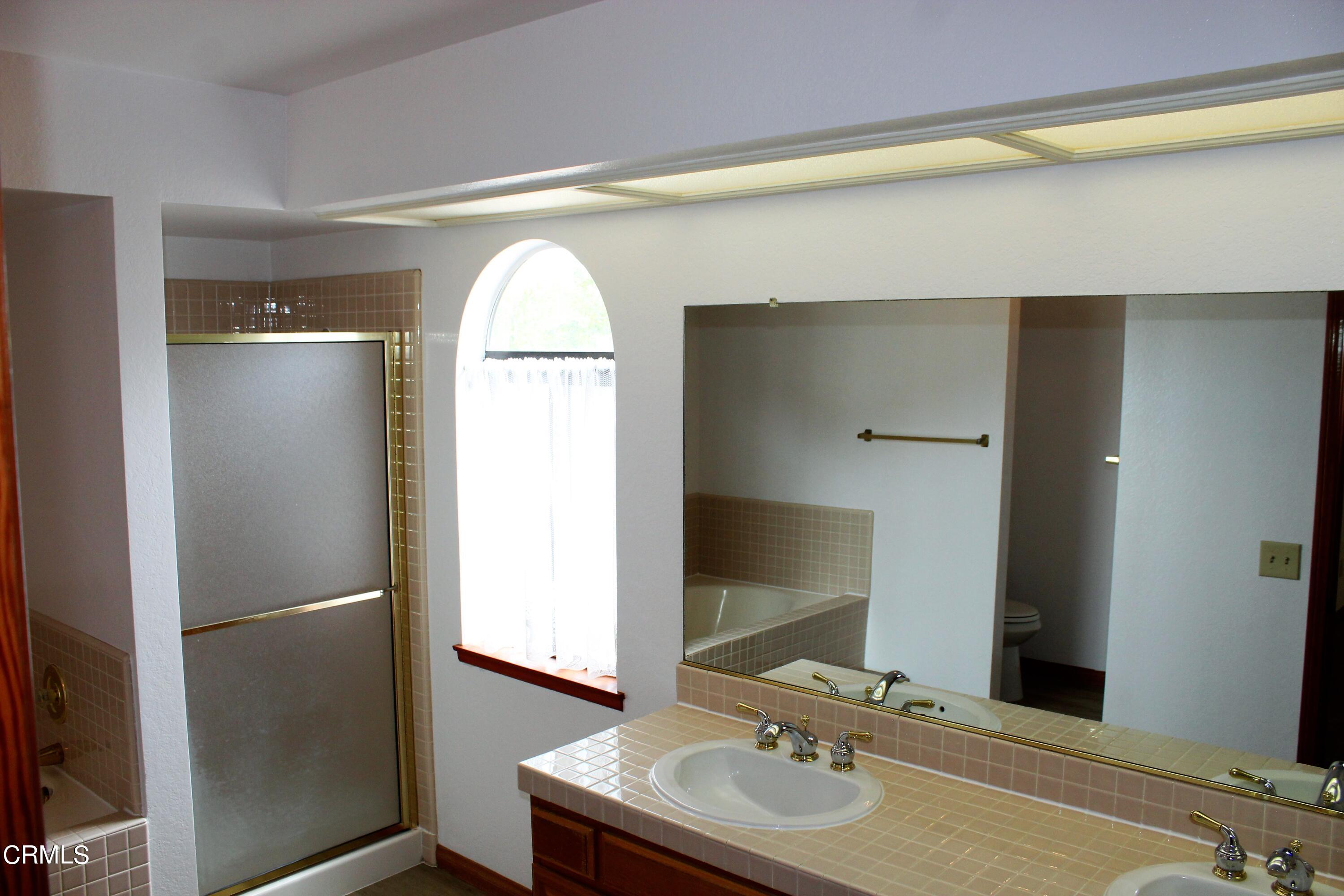 2202 Firestone Court Oxnard, CA 93036 - Photo 33 of 51 a bathroom with a sink and a mirror