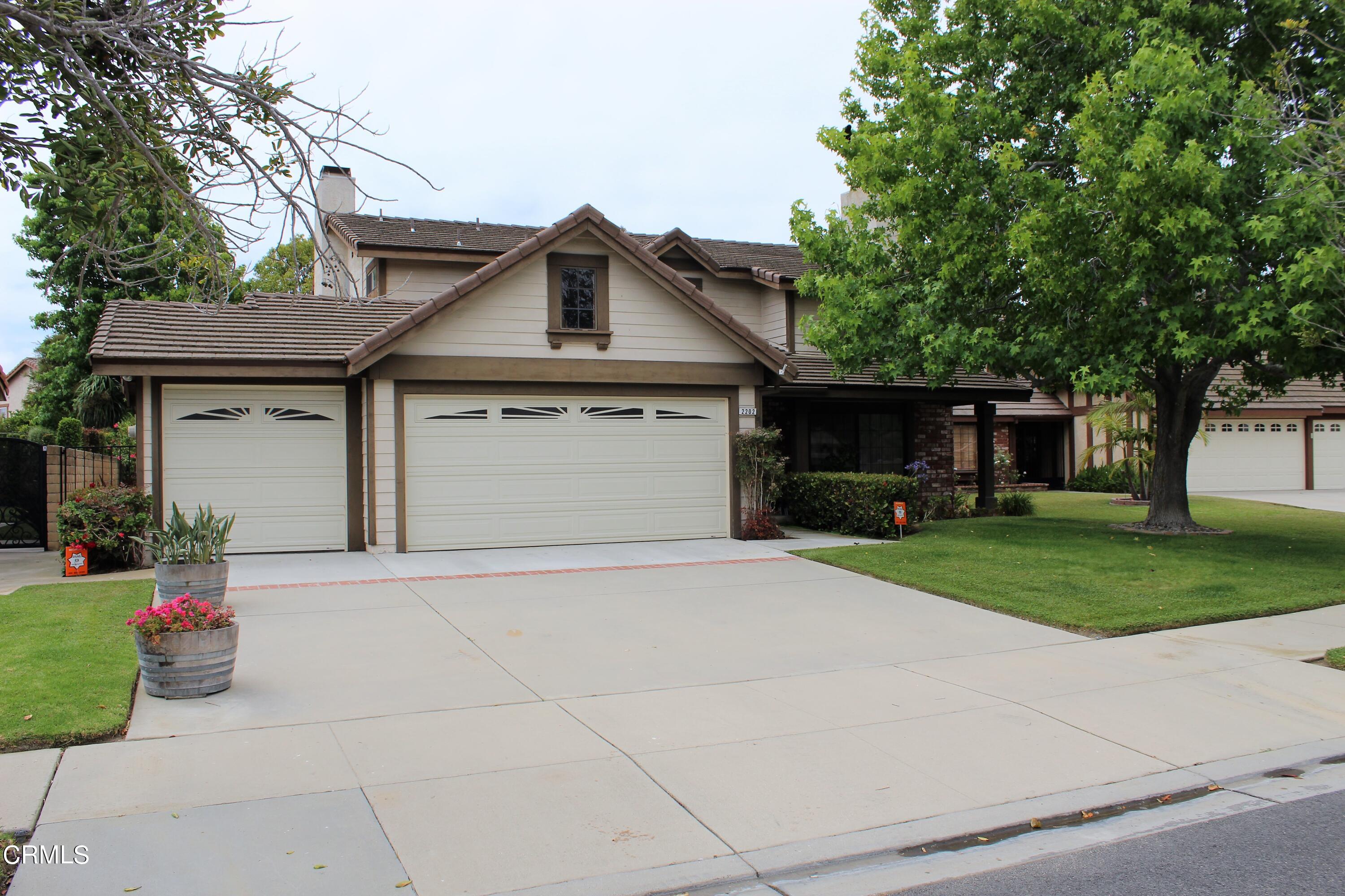 2202 Firestone Court Oxnard, CA 93036 - Photo 48 of 51 a front view of a house with a garden and trees