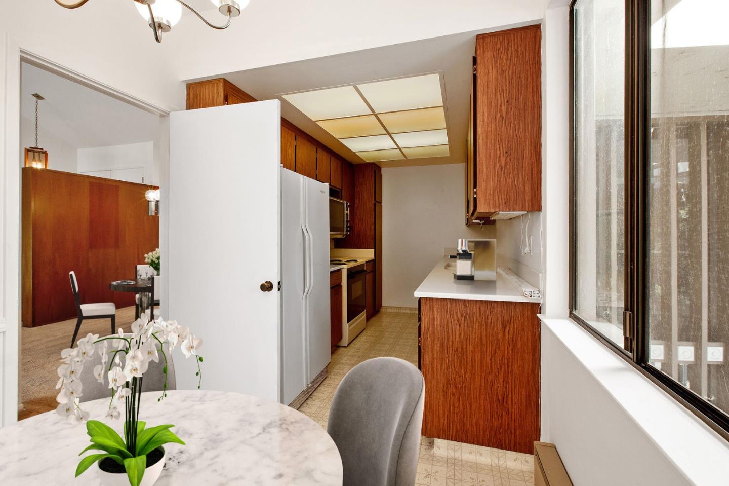 500 Almer Road, Unit 301 Burlingame, CA 94010 - Photo 9 of 24 a living room with furniture wooden floor and a chandelier