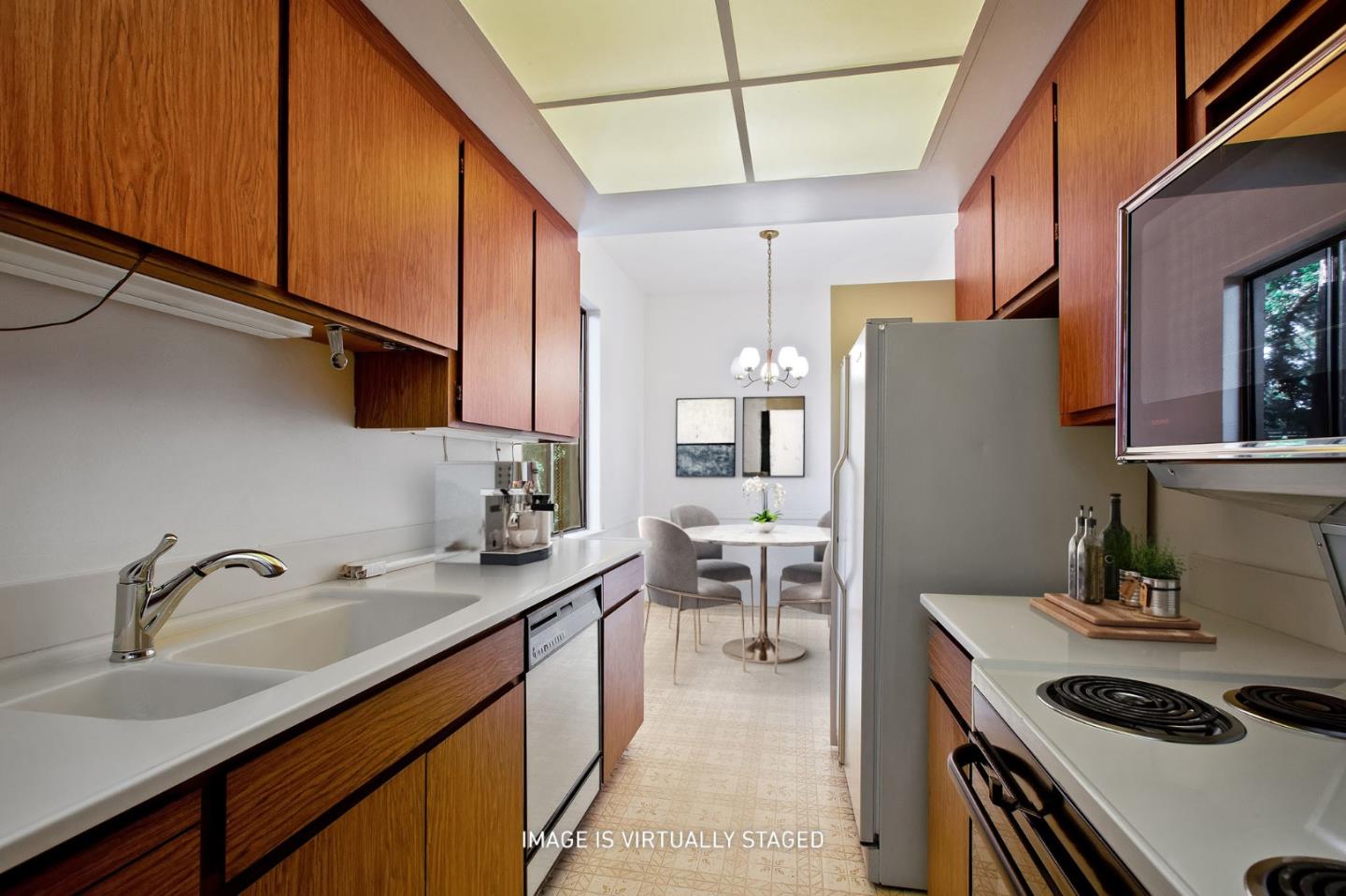 500 Almer Road, Unit 301 Burlingame, CA 94010 - Photo 10 of 24 a kitchen with furniture a sink and a refrigerator
