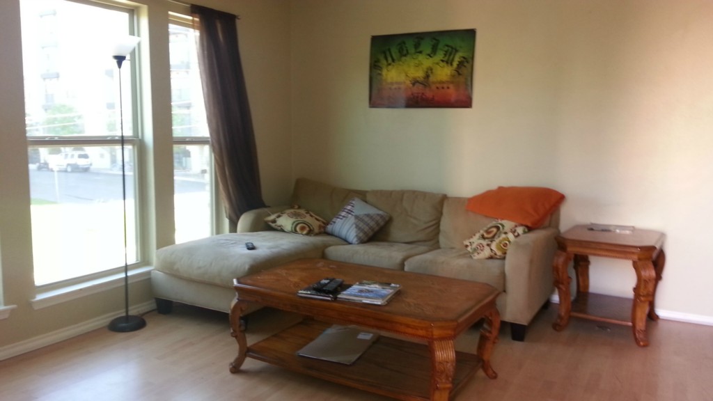 2414 Longview Street, Unit 201 Austin, TX 78705 - Photo 4 of 9 a bed sitting in a bedroom next to a window