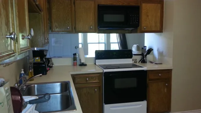 a kitchen with a sink appliances and cabinets