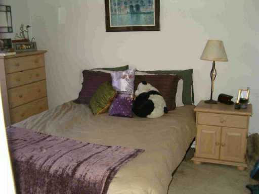 2414 Longview Street, Unit 201 Austin, TX 78705 - Photo 7 of 9 a bedroom with a bed and a lamp on dresser