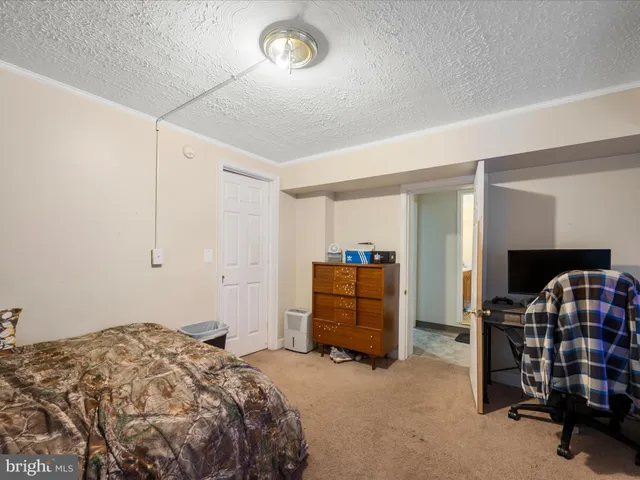 a view of a hallway with wooden floor and entryway