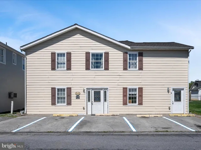 a view of a white house with a outdoor space