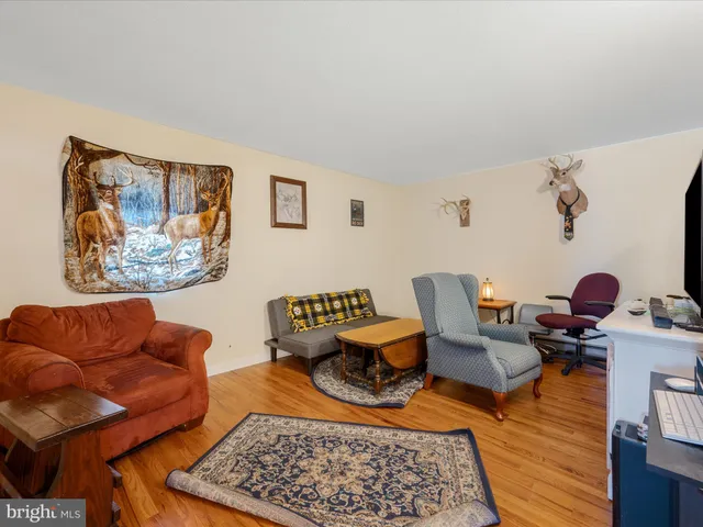 a bedroom with furniture and a wooden floor