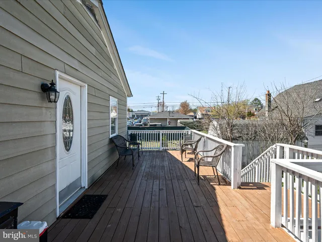 a view of a room with wooden floor and furniture