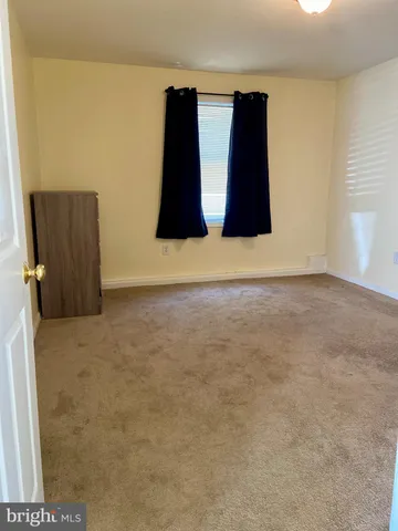 a bedroom with bed and a window