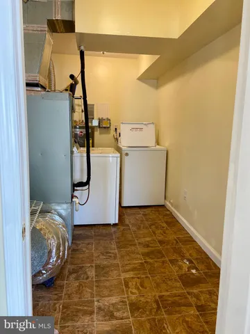 a balcony with wooden floor table and chairs
