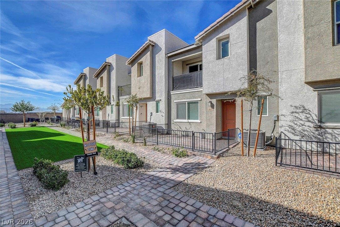 6924 Spicy Merlot Street North Las Vegas, NV 89086 - Photo 54 of 83 A contemporary row of homes awaits, each featuring a private patio area and access to a shared green space.