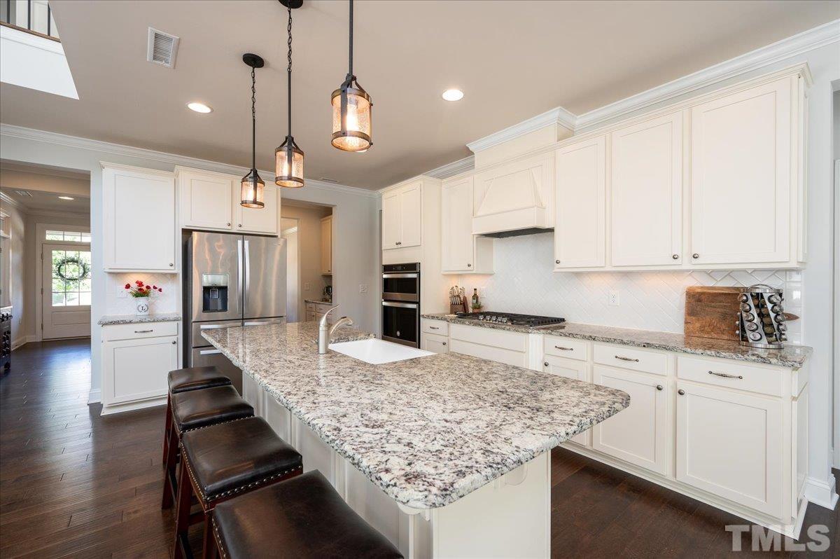 7108 Rex Road Holly Springs, NC 27540 - Photo 14 of 38 Farmhouse sink, a wall over + microwave combo and under cabinet lights are just a few of the amazing features of this kitchen.