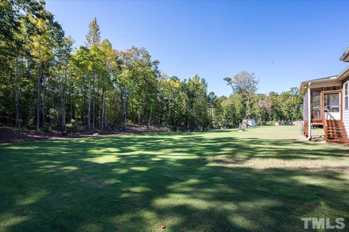7108 Rex Road Holly Springs, NC 27540 - Photo 3 of 38 This house sits on a 0.55 acre lot with private backyard views of nature with tall mature trees.