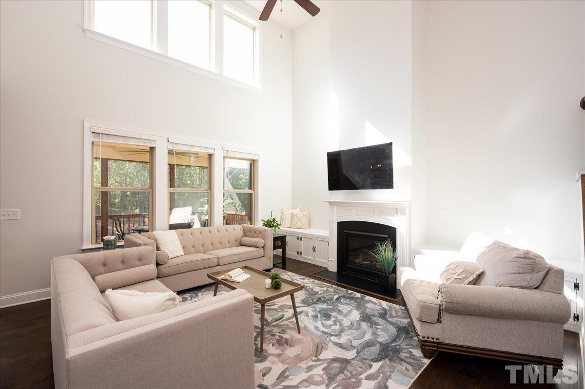 7108 Rex Road Holly Springs, NC 27540 - Photo 4 of 38 The 2-story living room receives so much natural light. This amazing space is great for entertaining or just chilling!